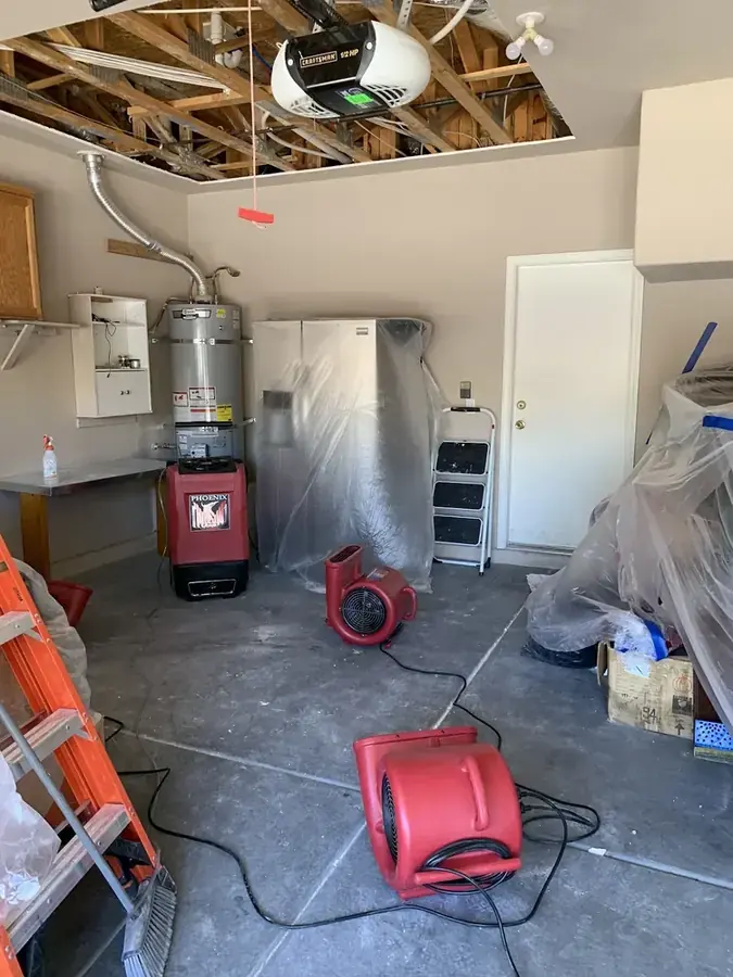 Failed water heater flooding a garage slab in a Peoria, AZ home